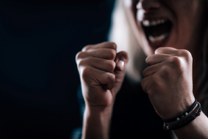a photo of someone with clenched fists and screaming indicating they might need a anger management program